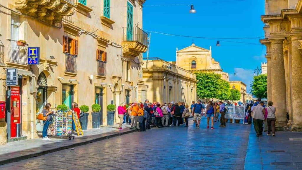 Towns and cities in Sicily, baroque street view of Corso Vittorio Emanuele in Noto with honey-colored architecture