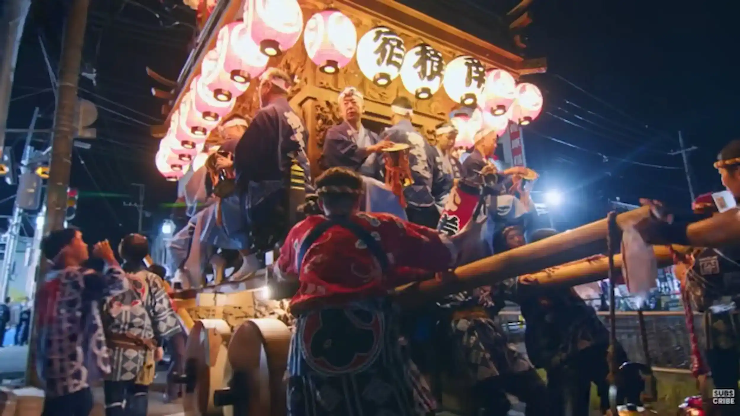 Illuminated festival float with paper lanterns and musicians during Sawara Grand Festival at night