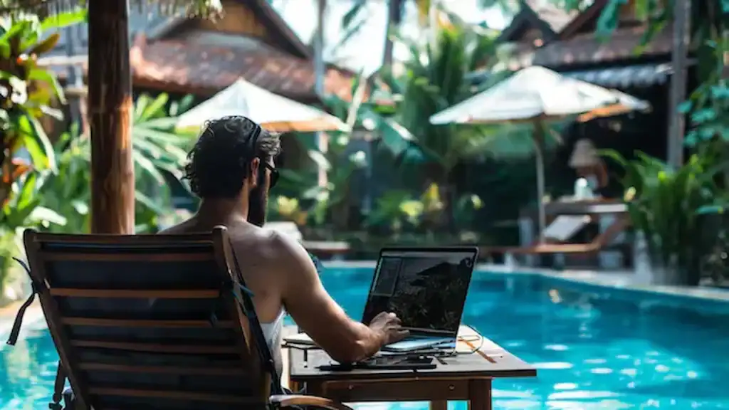 Bali digital nomad visa, man working his laptop by pool