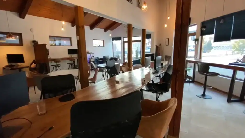 Bansko digital nomad workspace at Altspace coworking office with wooden beams and desks