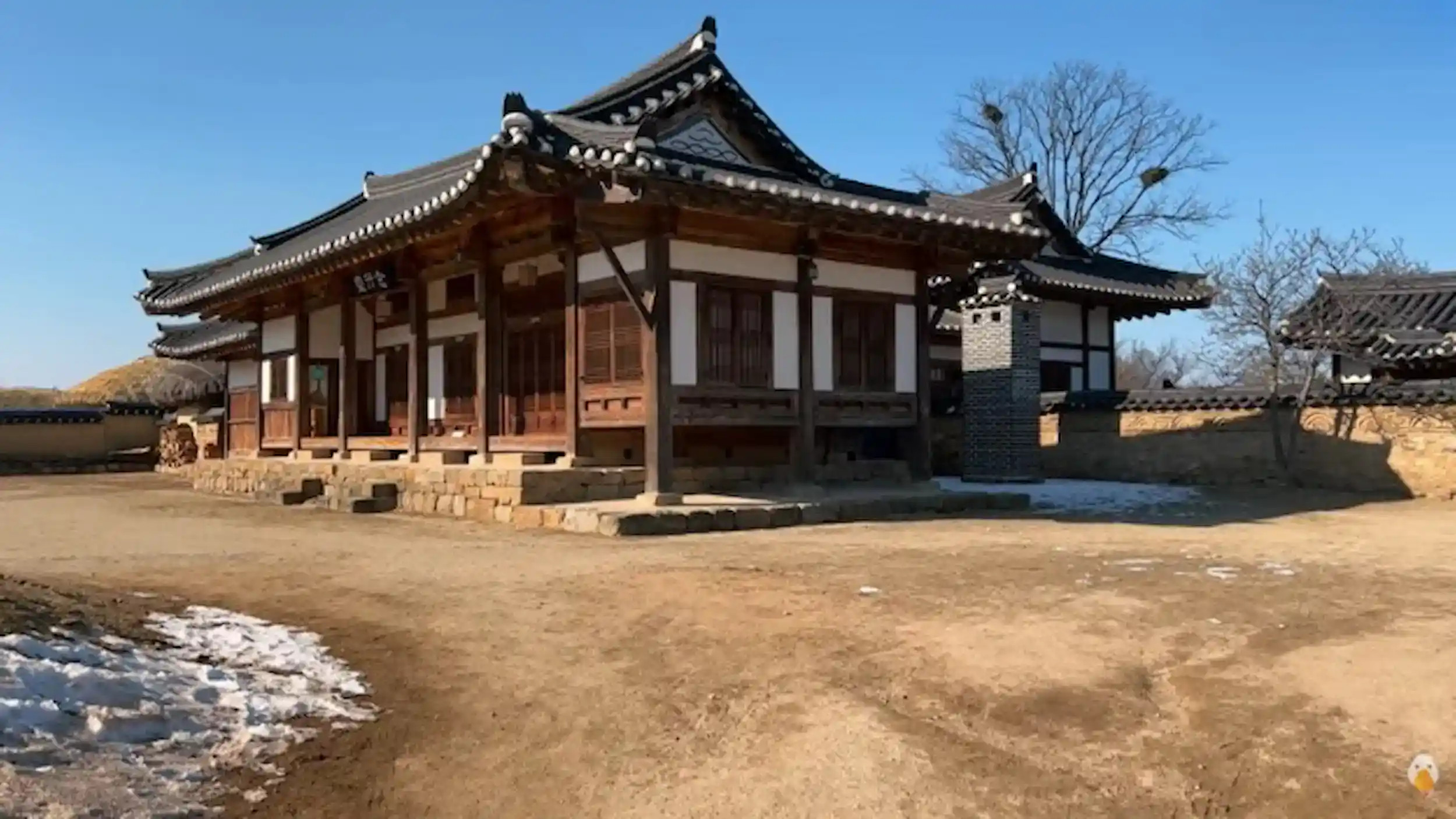 Things to do in Andong traditional hanok building at Andong Folk Museum with curved tile roof stone foundation and wooden architecture