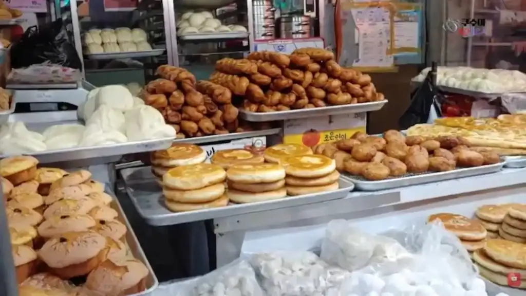 Variety of Korean street food snacks and pastries displayed at Ansan markets food stall
