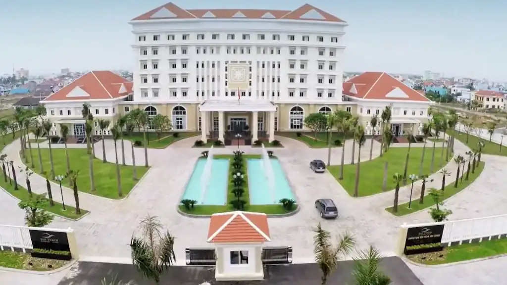 Ban Thach Riverside Hotel with grand white facade twin pools and manicured gardens
