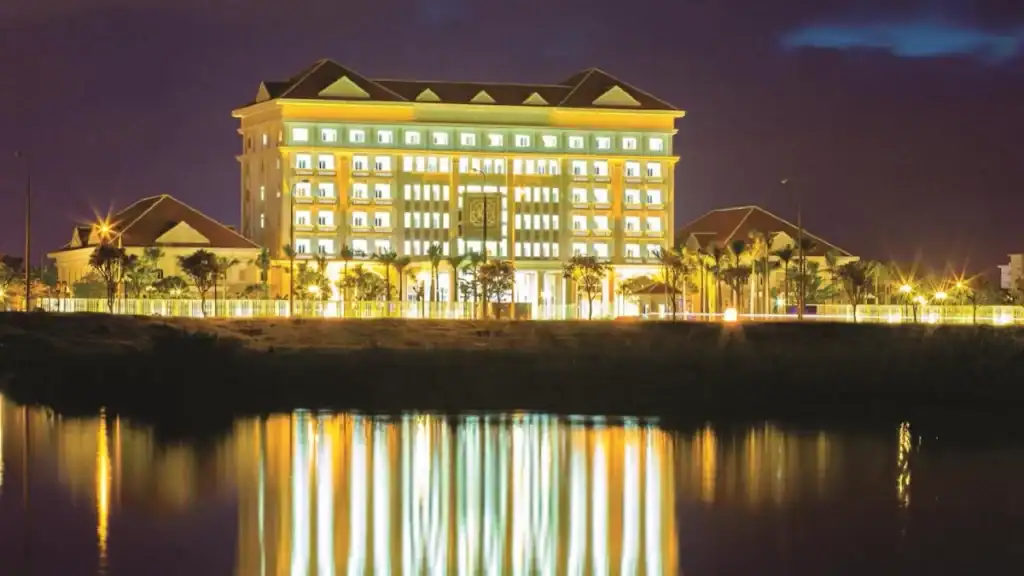 Ban Thach Riverside Hotel and Resort illuminated at night showcasing accommodation in Tam Ky vs Hoi An