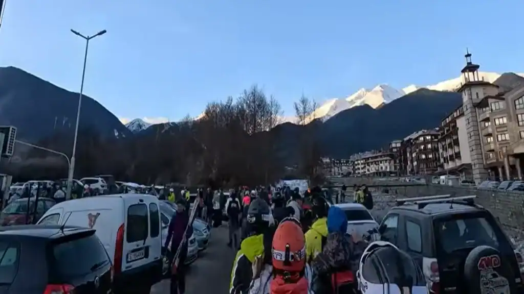 Bansko summer vs winter gondola queue with skiers walking through town