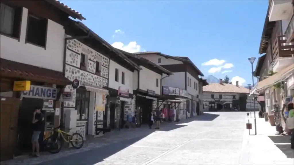 Bansko digital nomad exploring old town street with traditional architecture and mountain views