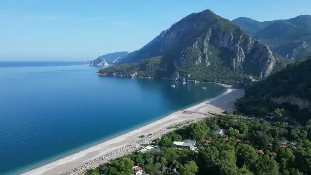 Olympos vs Çıralı beach aerial view showing Mediterranean coastline with mountains, turquoise waters, and sandy shore