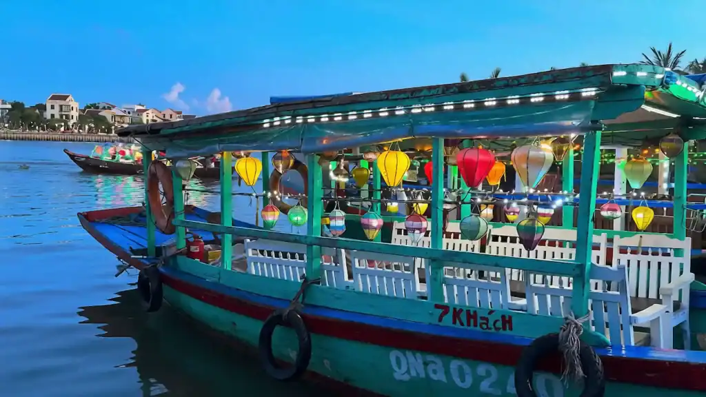 Colorful tourist boat decorated with lanterns on Hoi An river, a must-see when considering how many days in Hoi An.