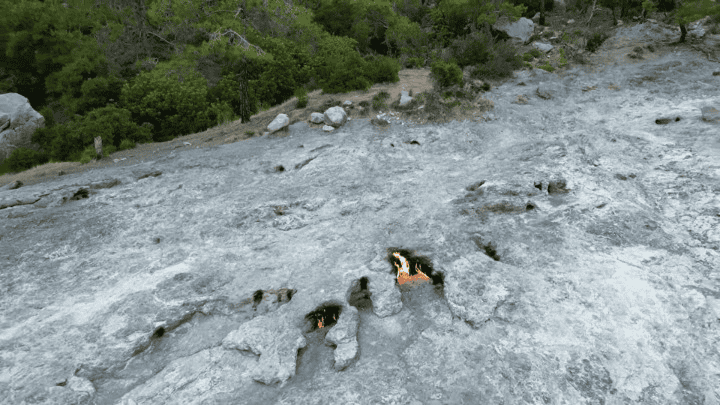 Olympos day trip Antalya Yanartas eternal flames emerging from rocky mountain terrain