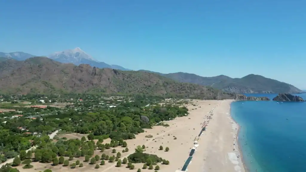 Çıralı aerial beach view with snow-capped mountains and bay