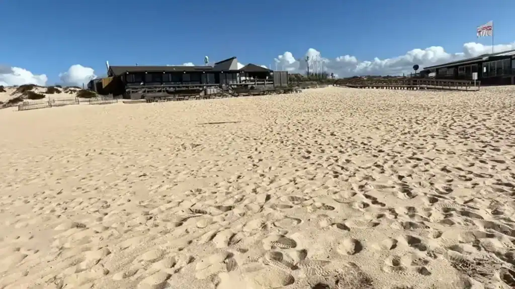 Comporta beach restaurant with wooden terrace overlooking golden sand and Atlantic coastline