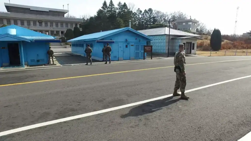 Andong cultural experience Korean DMZ Joint Security Area with blue conference buildings military guards and demarcation line at Panmunjom border