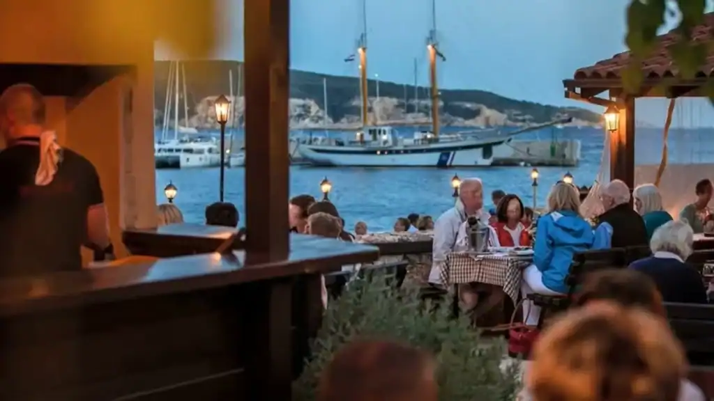 Vis Town vs Komiza waterfront dining with sailing boat views at dusk