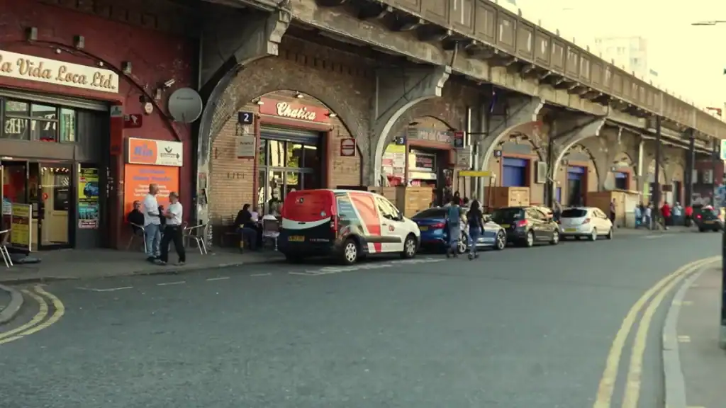 Is Elephant and Castle safe showing busy railway arches with local businesses and pedestrians