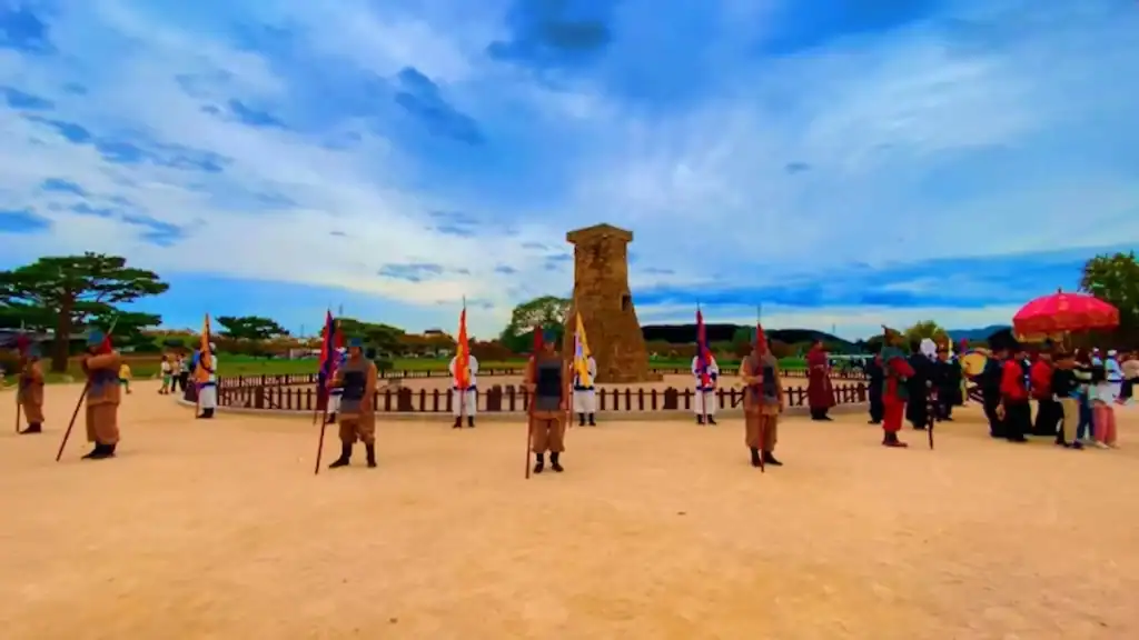 Andong vs Gyeongju ancient Cheomseongdae Observatory tower in Gyeongju with traditional guards and tourists at historic Silla Dynasty site