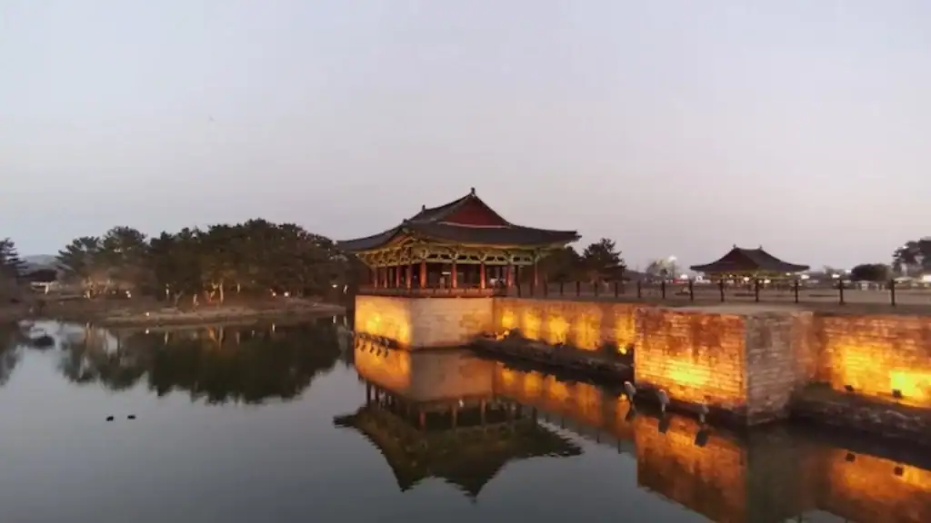 Gyeongju illuminated Donggung Palace and Wolji Pond in Gyeongju at dusk with golden lights reflecting on water