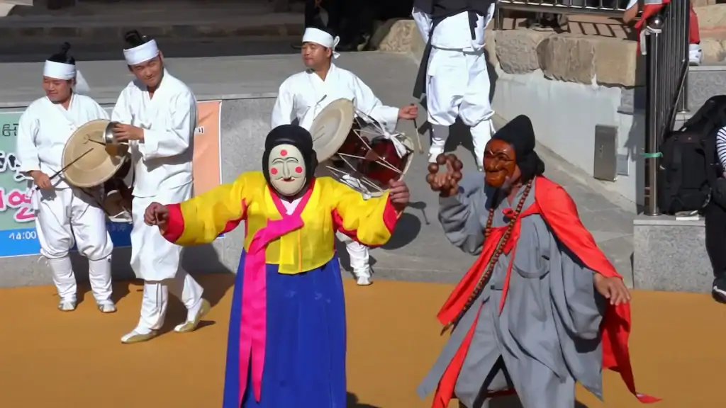 Things to do in Andong traditional Hahoe mask dance performance with colorful costumes wooden masks and traditional Korean musicians playing drums