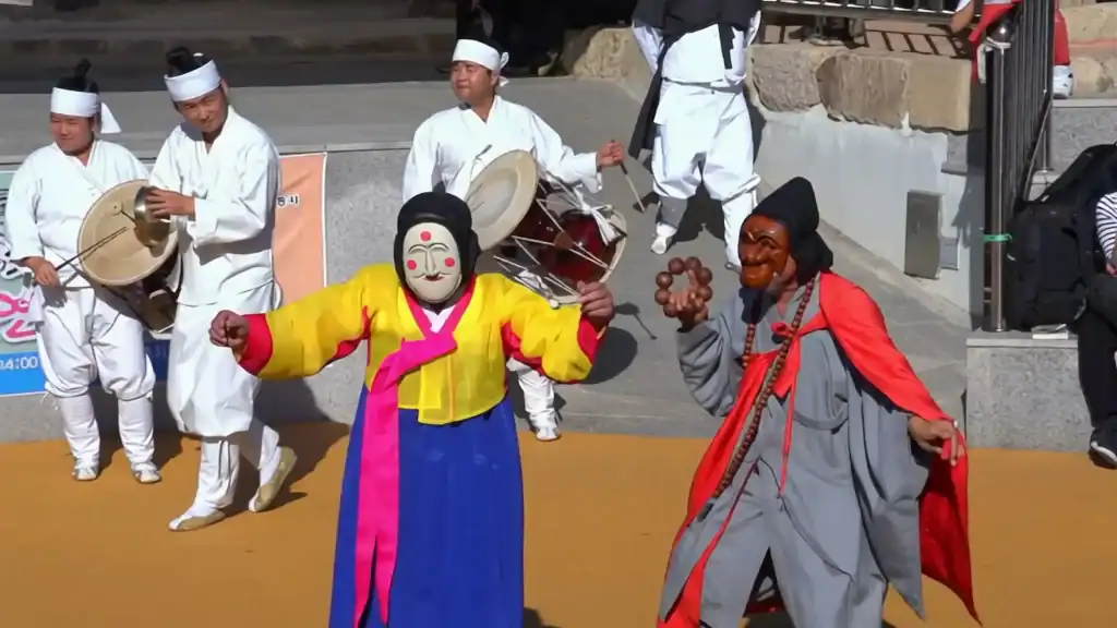 Andong cultural experience Hahoe mask dance performance with colorful traditional costumes wooden masks and traditional Korean musicians with drums