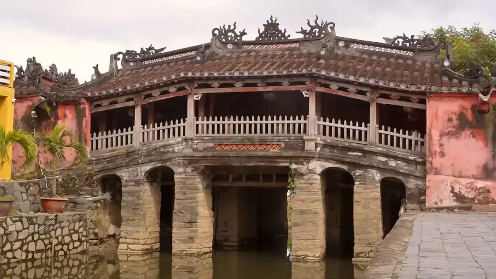 Historic Japanese Covered Bridge with ornate roof.