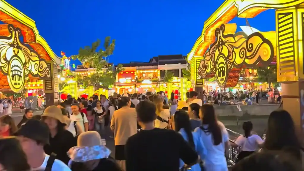 Crowded Japanese Covered Bridge area at night with illuminated decorations, highlighting