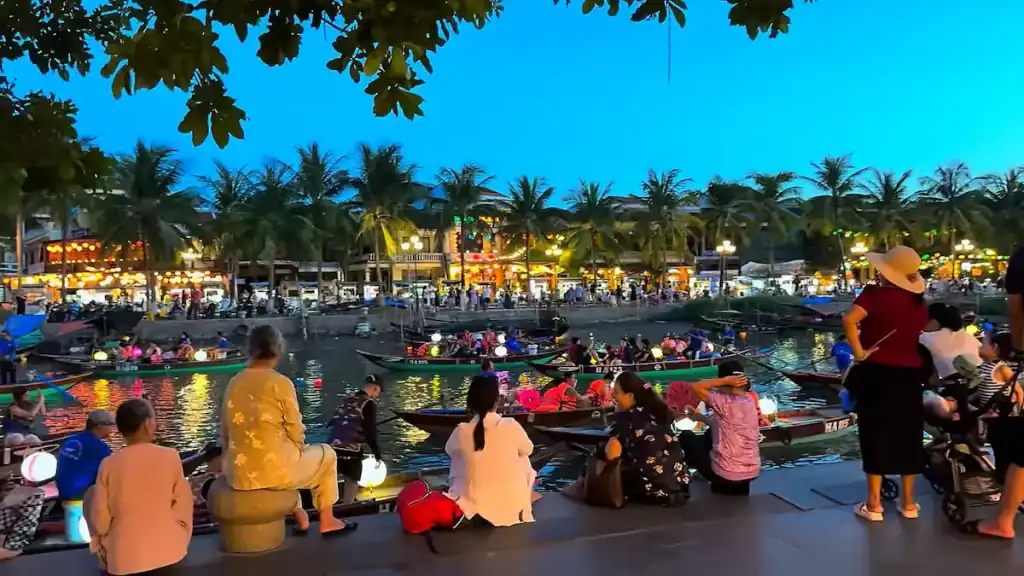 Hoi An evening lantern festival with boats contrasts with cheap alternative to Hoi An budget destinations