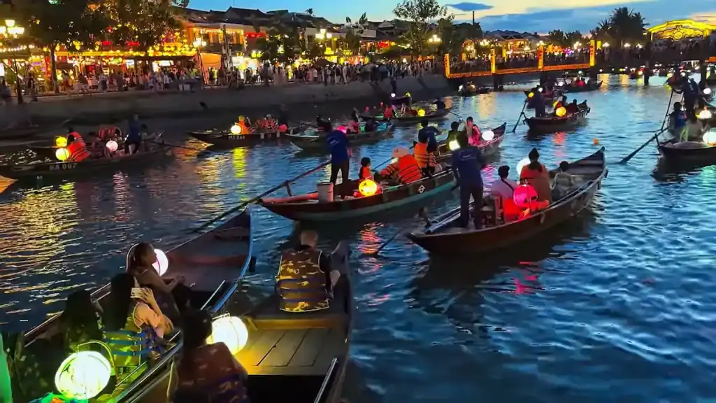 Lantern festival on Thu Bon River with colorful boats at dusk,