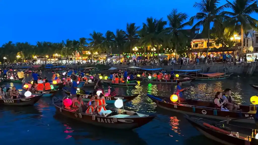 Lantern festival shows colorful boats on the river at dusk.