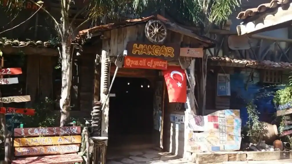 Olympos Treehouse Accommodation. Hangar bar with rustic wooden entrance and decorations