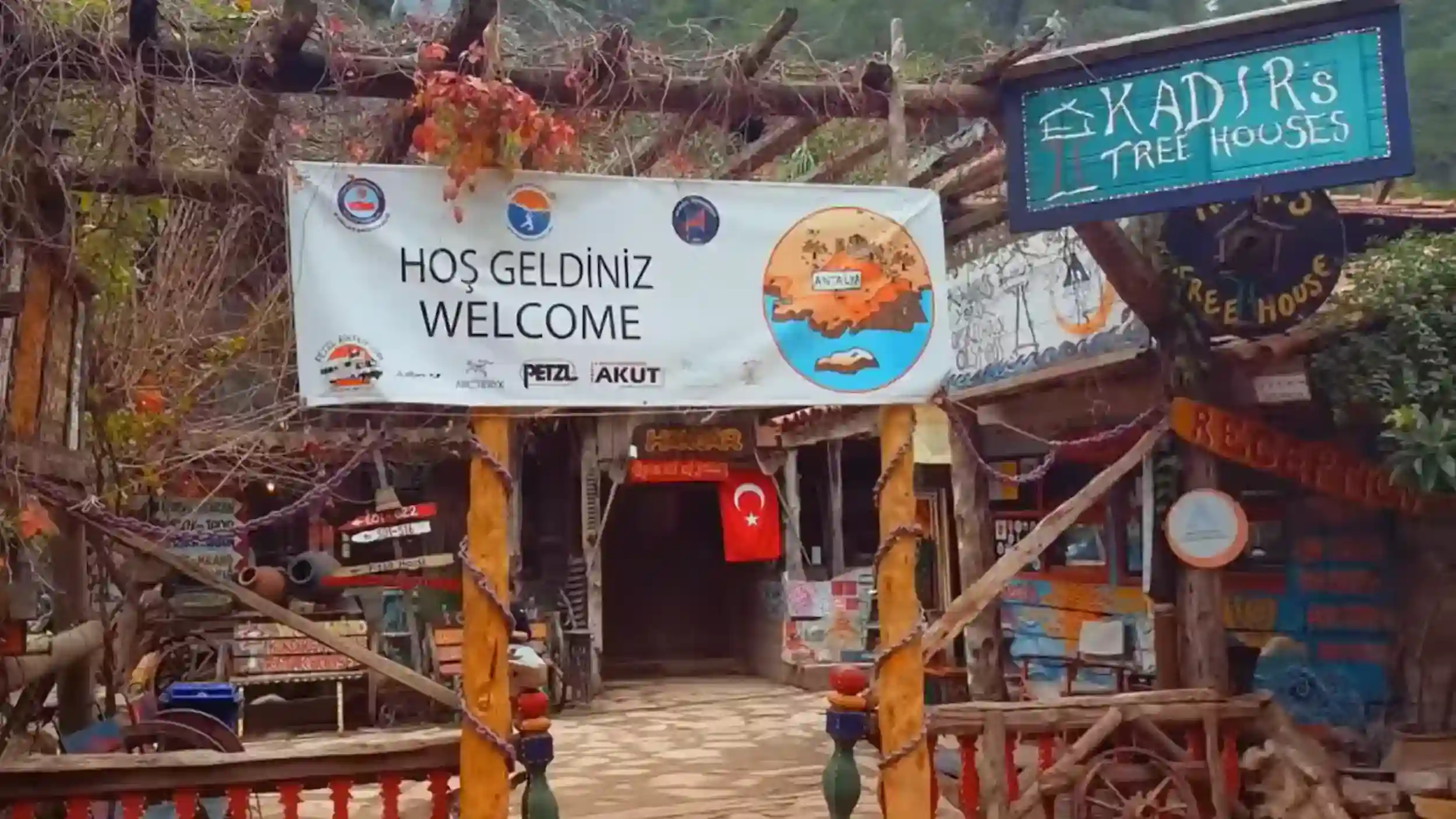 Olympos Treehouse Accommodation entrance gate with welcome sign and colorful bohemian decorations