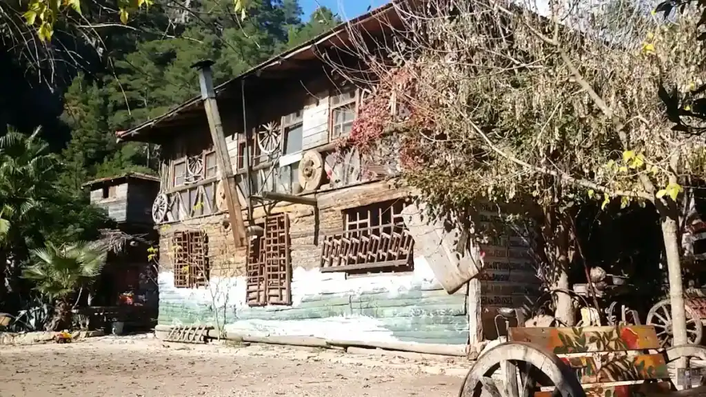 Olympos Treehouse Accommodation rustic wooden structure with eclectic artistic decorations and balcony