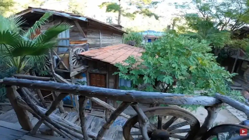 Alt Tag:
Olympos vs Çıralı Kadir's Treehouse buildings with rustic wooden structures, lush tropical plants, and unique bohemian architecture
