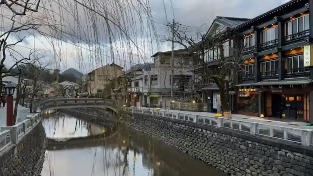 Is Kinosaki Onsen worth it - scenic canal with stone bridge and traditional ryokans in historic town