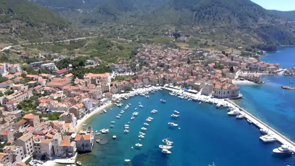 Vis Town vs Komiza aerial view showing Komiza harbour with moored boats