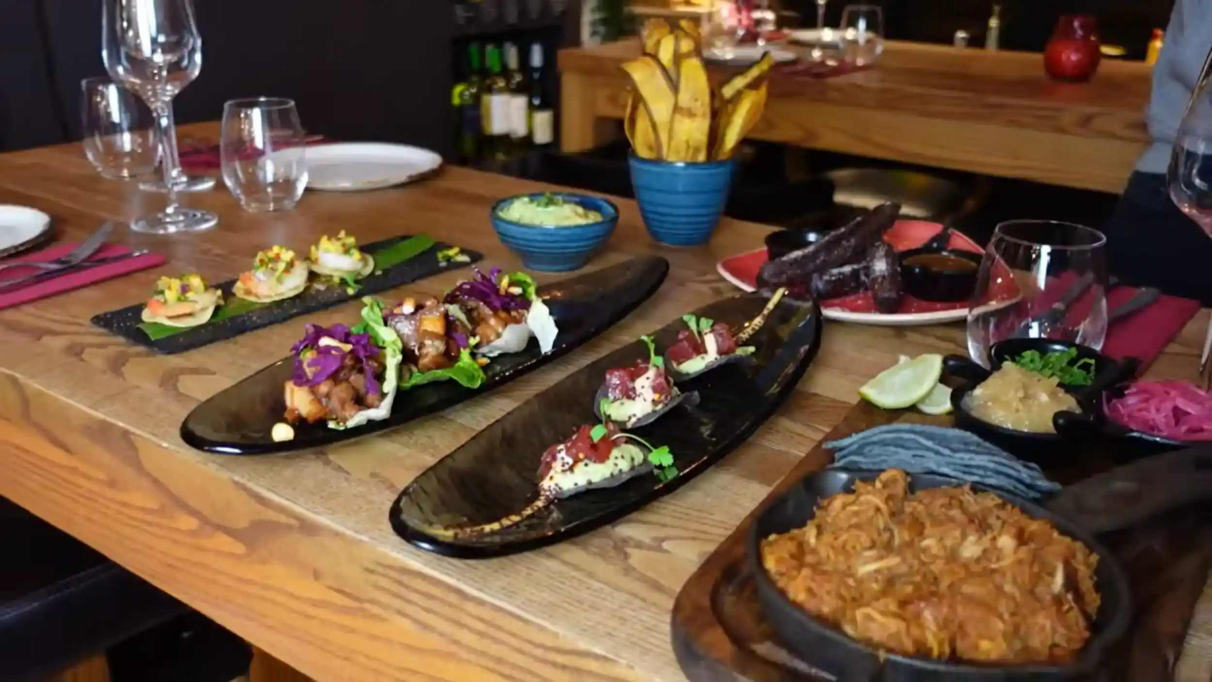 Elephant and Castle latin restaurants tapas spread with tacos, plantain chips, guacamole and traditional dishes