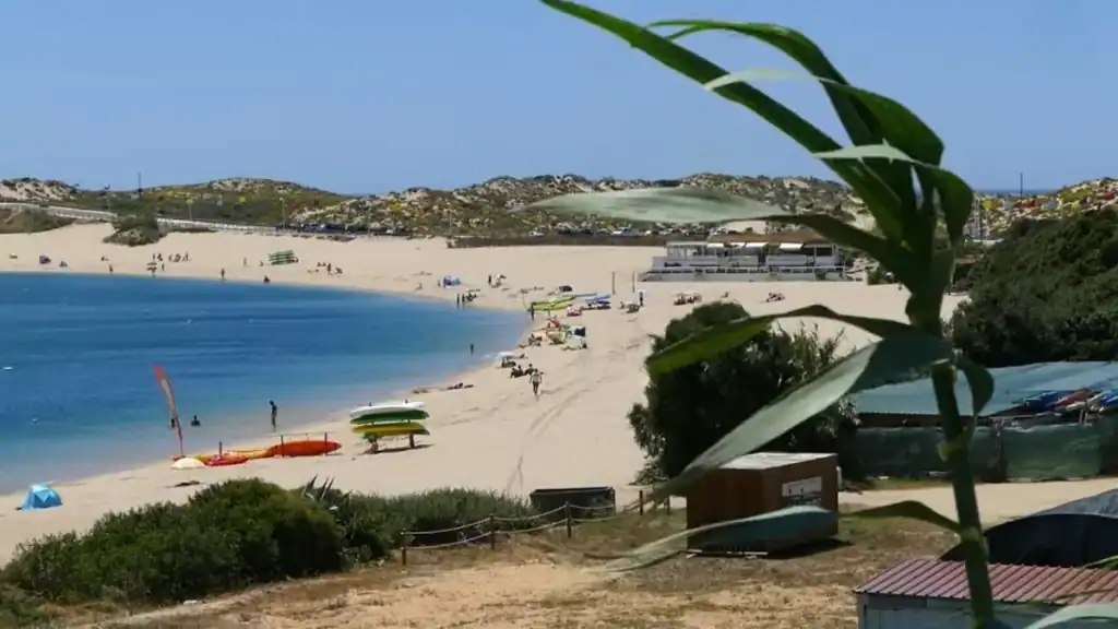 Beach with colorful kayaks and sunbathers