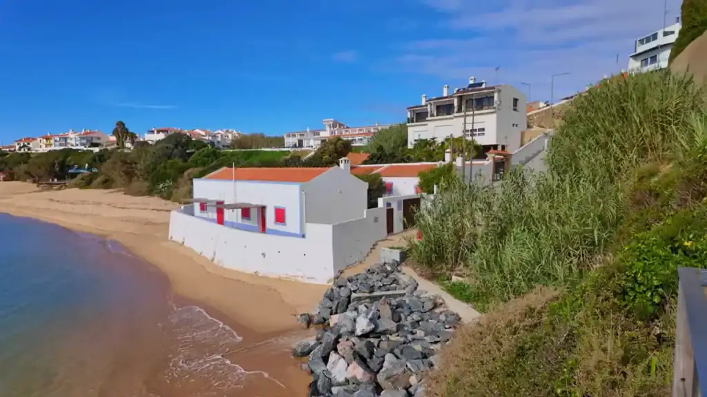 Where to Stay in Milfontes showing beachfront apartments and houses along the sandy shore