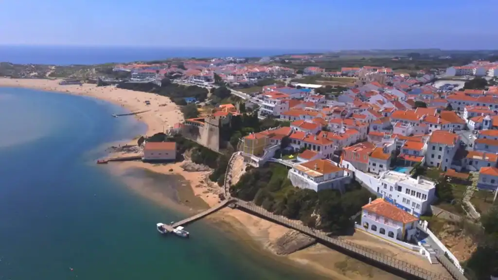 Aerial view of coastal town and beach at Milfontes how many days to explore