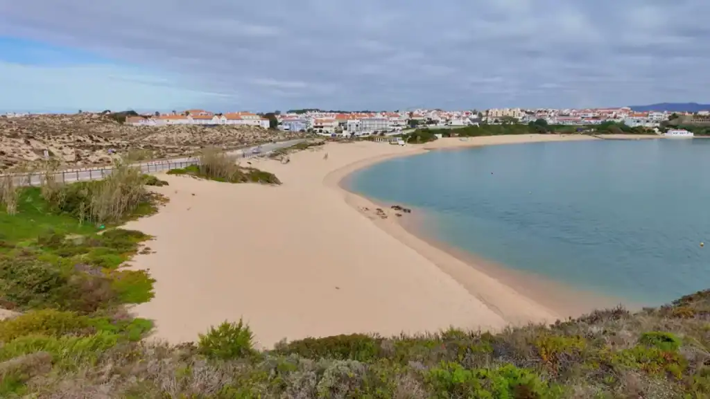 Tranquil beach outside town with views of village