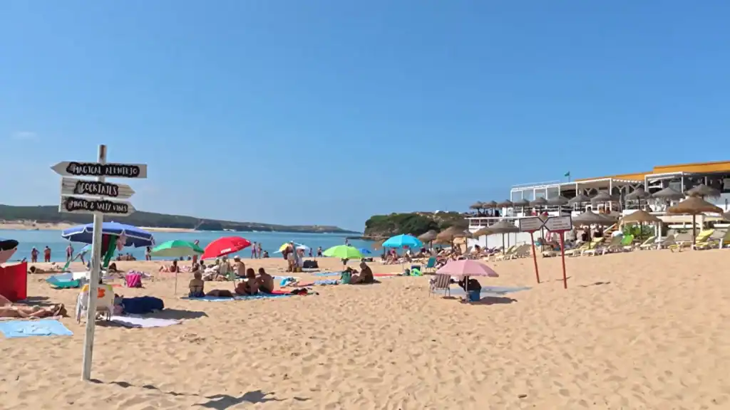 Milfontes beach restaurant with colorful umbrellas and dining showing is Milfontes worth it visit
