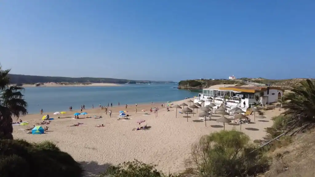 Where to Stay in Milfontes with estuary beach showing calm waters and beachfront facilities