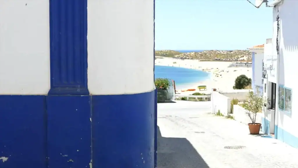 Street with blue trim overlooking beach
