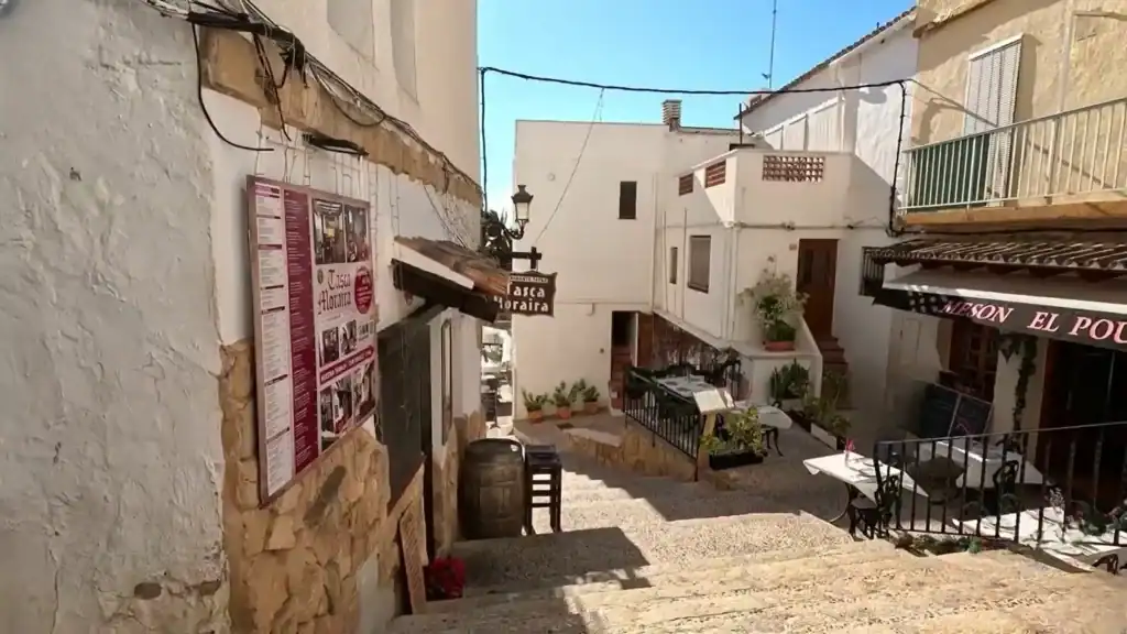 Moraira morning view of quiet whitewashed streets with traditional buildings and shops.
