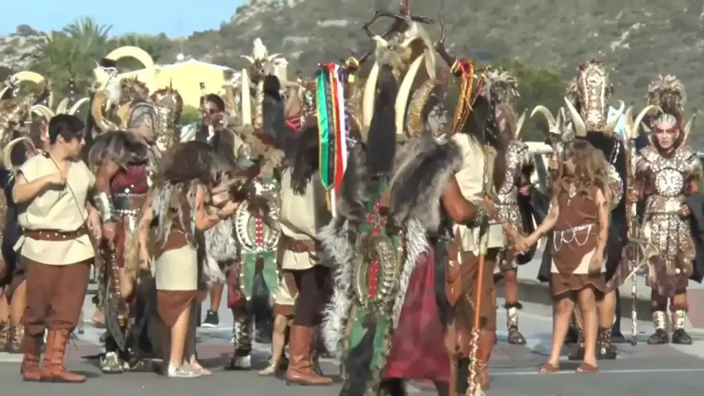 Moros Y Cristianos festival showing elaborately costumed performers parading.