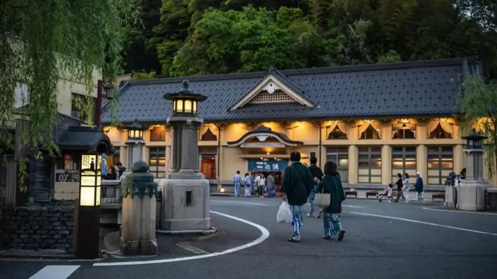 one night in Kinosaki Onsen - visitors in yukata walking toward Ichino Yu bathhouse at dusk