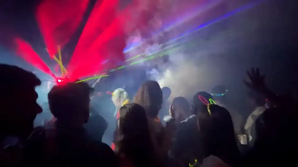 Bansko digital nomad enjoying nightlife party with laser lights and smoke effects indoors