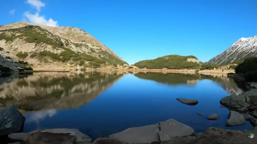 Pristine mountain lake with crystal reflections in Pirin National Park near Bansko in summer