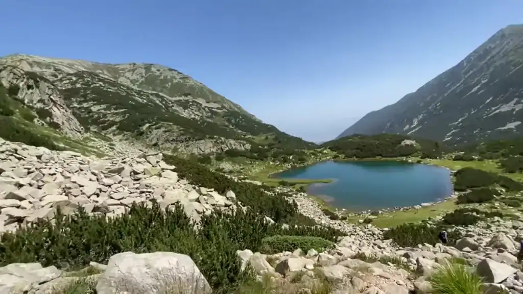 Bansko summer vs winter mountain lake surrounded by green peaks in Pirin