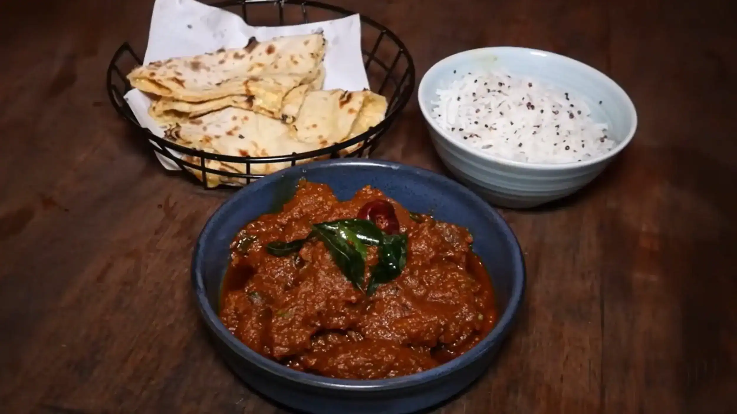 Curry dish from Kachori among Elephant and Castle restaurants with naan bread and raita side accompaniment