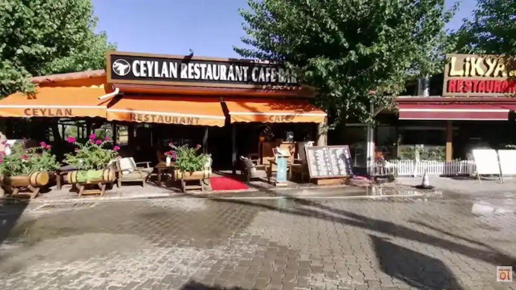 Olympos vs Çıralı. Çıralı restaurants in Çıralı showing Ceylan Restaurant Cafe with orange awnings and outdoor seating area