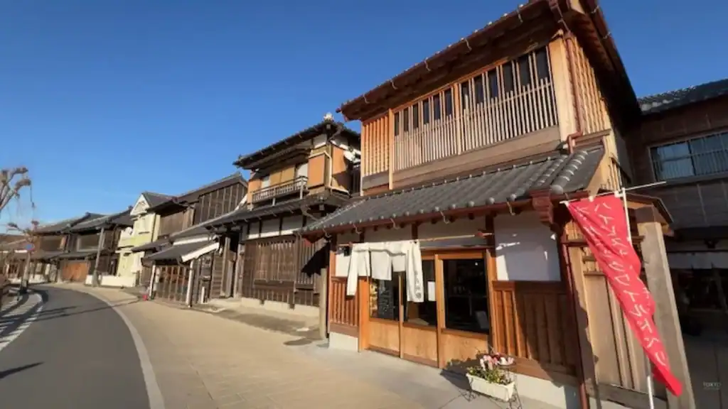 Traditional wooden merchant houses with latticed facades line a historic street in Sawara, Japan